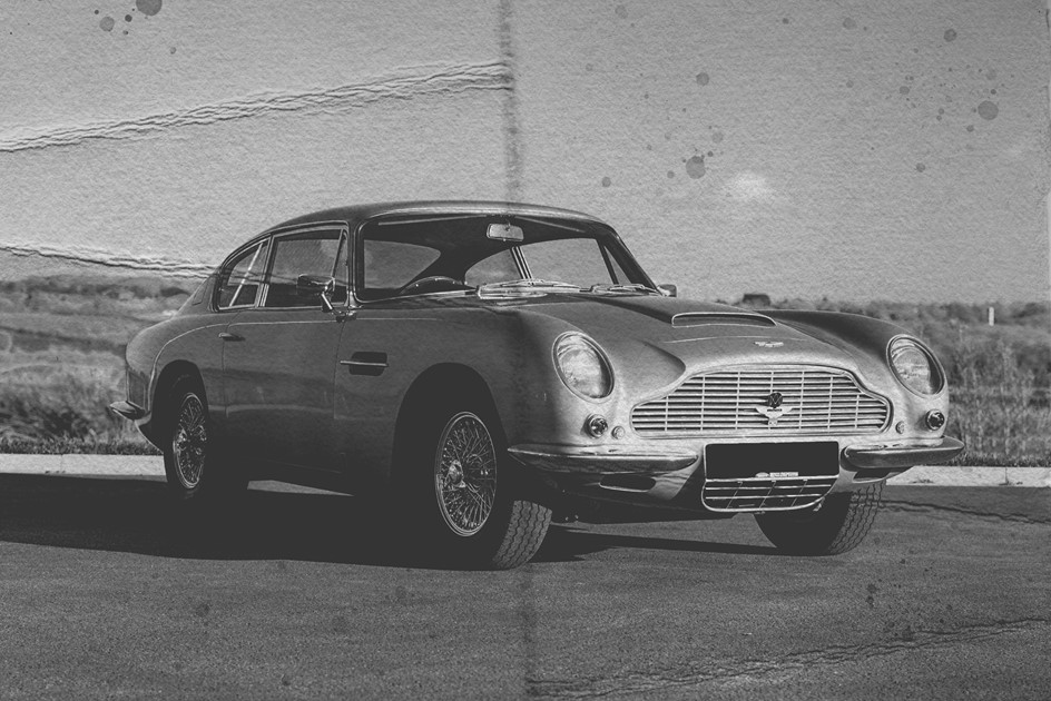 A classic Aston Martin DB6 in a period style photo outside PaddlUp