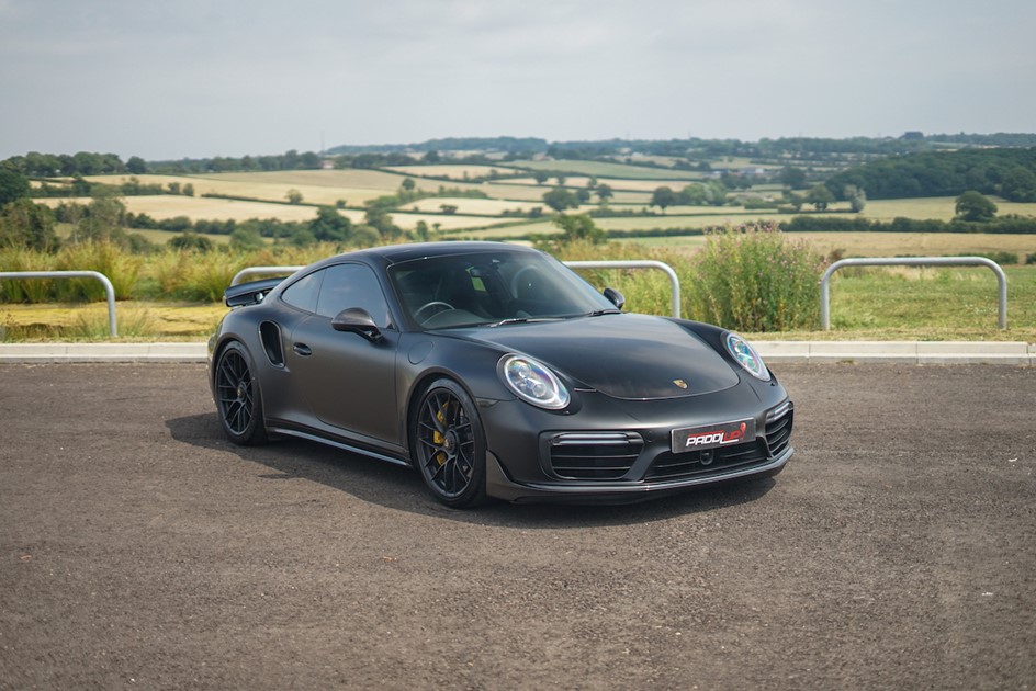 A black Porsche 991.2 911 Turbo S outside the PaddlUp showroom