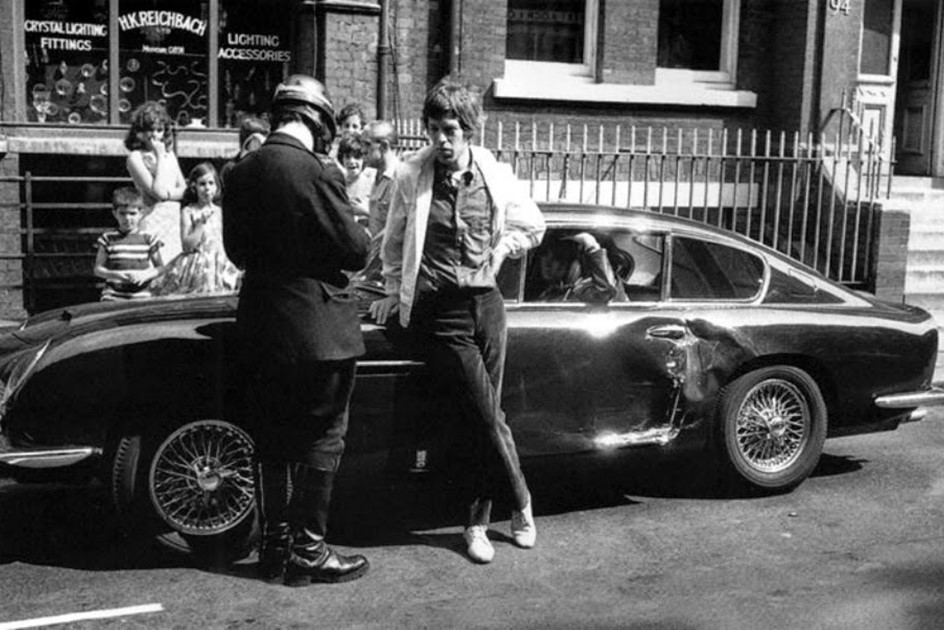Mick Jagger next to his Aston Martin DB6