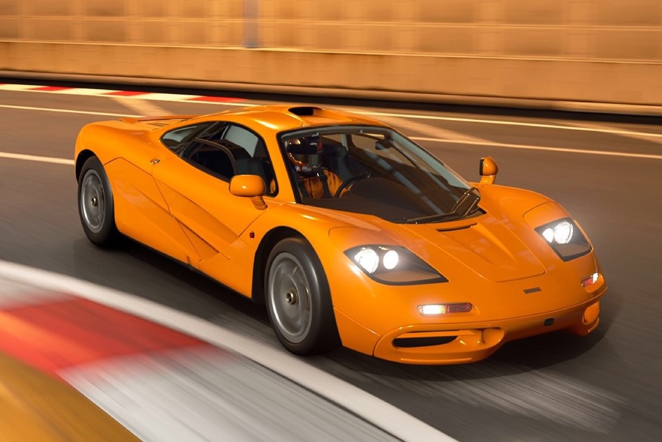 An orange McLaren F1 hypercar cornering at high speed